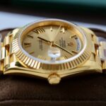 Super Clone Rolex Day-Date Roman Champagne Dial 228238 40 mm — on leather display