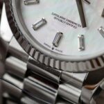 Super Clone Rolex Day-Date White Mother-of-Pearl Diamond Dial 128236-0021 36 mm — on leather display